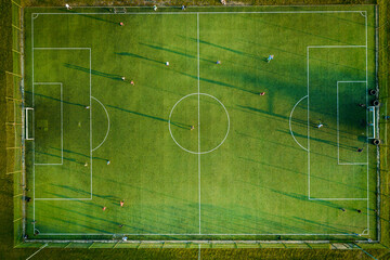 Aerial drone top view photo of football pitch as seen in small mediterranean village. © Polivan