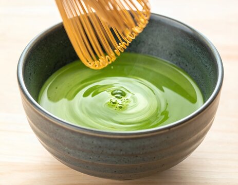 Traditional Japanese Matcha Tea Preparation with Bamboo Whisk in a Ceramic Bowl.
