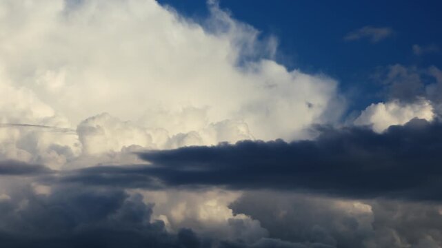 Timelapse of dark storm clouds moving rapidly across the sky as weather deteriorates before a thunderstorm, dramatic atmospheric buildup with dense thundercloud formations signaling approaching severe