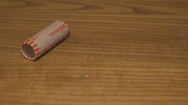 Pulling one rolled sleeve of quarters off screen.