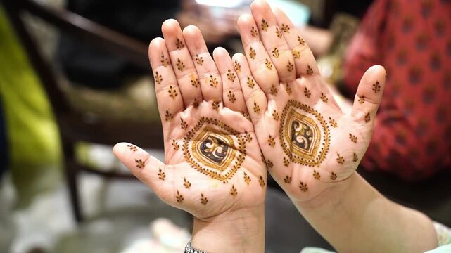 Stunning Indian bride showcasing her intricate bridal Mehendi designs on her palms during a traditional wedding celebration