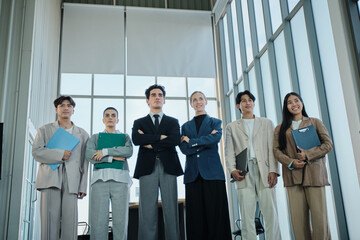 Obraz premium Multiracial Businessperson partnership team, confident standing together with determined looking, synergy and harmony, business firm worker people with solidarity motivation, corporate company vision.