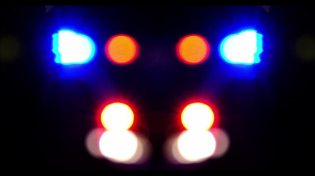defocused video of the sires of a police squad car outside in the night