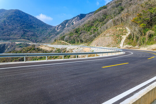 Sharp curve on a scenic mountain highway winding through green forests