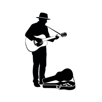 Silhouette of a Musician Playing Guitar on Street.