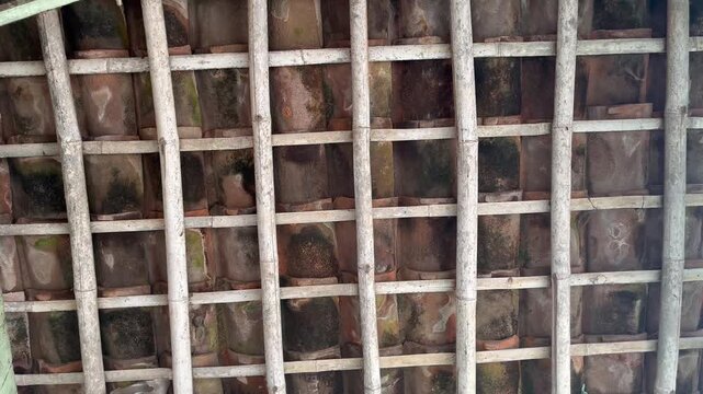 Traditional terracotta roof tiles on a wooden house structure