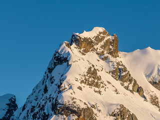 Sunlit Snow-Covered Mountain Peak at Golden Hour, British Columbia, Canada Alpine Landscape © edb3_16