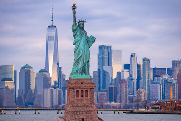 American vote and democracy. Manhattan by the Statue of Liberty. Elections in USA. New York City skyline with Liberty Statue. Manhattan skyscrapers near Statue of Liberty. Symbol of Freedom in USA. © Volodymyr