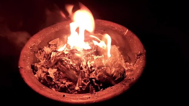 Fire burns white paper on fireplace