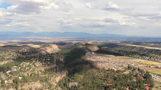 A cinematic drone flight over the stunning Los Alamos mesa and canyon scenery. This epic Southwest landscape footage highlights unique geological formations and a dense Ponderosa forest.