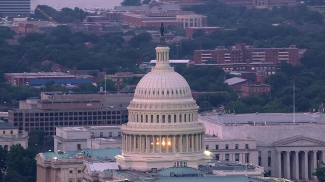 Cinematic aerial drone footage of the United States Capitol building in Washington, D.C., showcasing its iconic dome and classic architecture from a high-angle perspective.