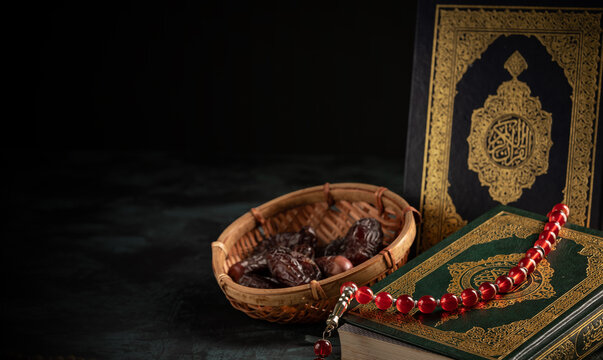 Holy Quran with prayer beads and dates in wicker basket