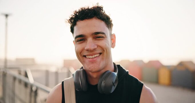 Laugh, fitness and face of man outdoor with headphones for exercise, training and workout for wellness. Happy, runner and portrait of person smile for challenge, health and active hobby in morning