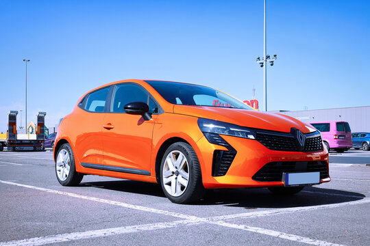 Poznan, Poland - April 2, 2026. Stylish orange Renault Clio 5th generation model from 2023 in a parking lot.