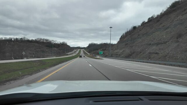Driving Through Appalachian Mountains in Spring Under Cloudy Sky