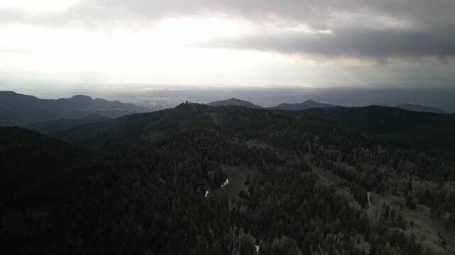Springtime aerial above Lincoln National Forest with stormy sky in Cloudcroft New Mexico