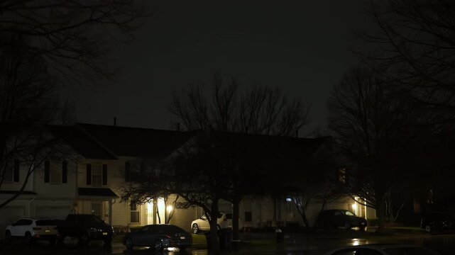 Intensive Flashing lightening of thunderstorm strike the sky above the residential house. 