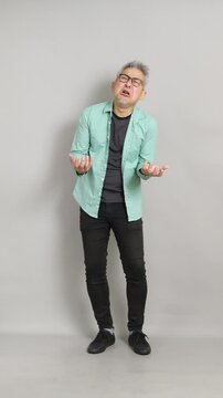 A 50-year-old Chinese man dramatically crying, complaining, and showing extreme emotional distress toward the camera.