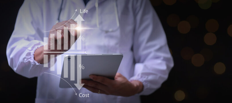 Focused doctor holding tablet analyzing digital graph showing increased healthcare efficiency and reduced cost for modern medical clinic