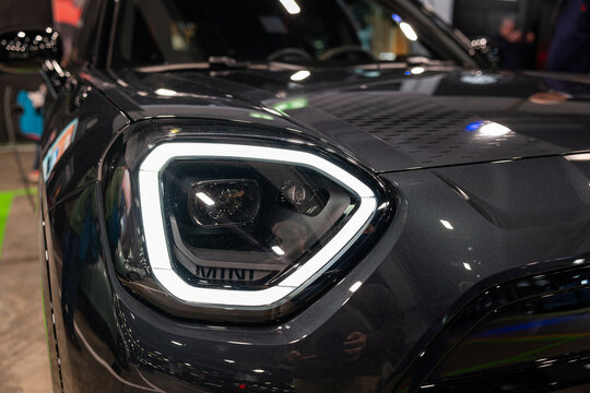 Zurich, Switzerland, October 10, 2025. Detailed front angle close up of the Mini Countryman LED headlight and brand lettering at the Zurich Auto Show