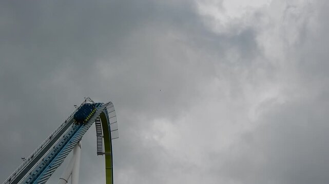People Are Climbing Steep Roller Coaster Tracks on Cloudy Day