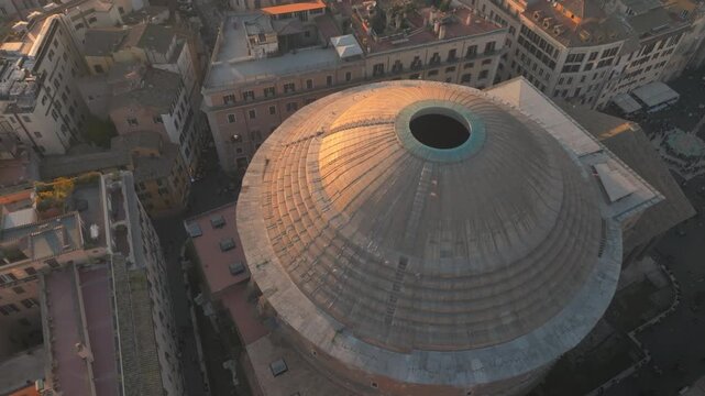Aerial drone View Of The Pantheon's Dome And Its Oculus At Sunset In Rome, Italy. tilt-down shot