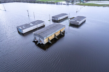 Industrial buildings surrounded by flood water The Concept of Environmental Crisis