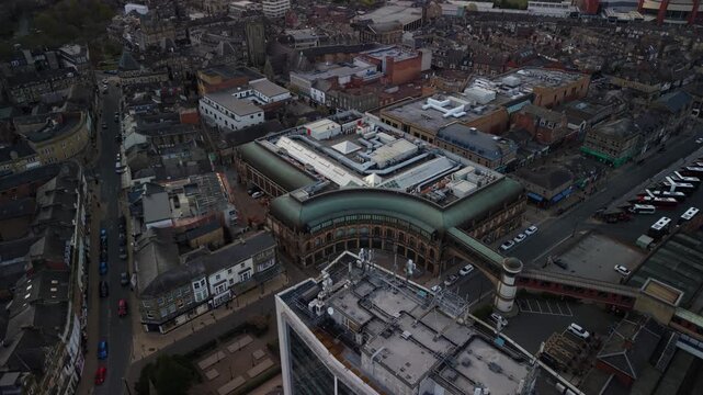 Drone pulls away from Victoria Shopping Centre in Spa Town of Harrogate North Yorkshire revealing the town landscape