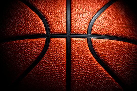 Detailed basketball surface texture with dramatic lighting. Abstract sports background.