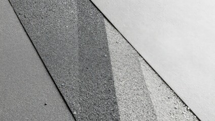 Fototapeta premium Two surfaces meet at an angle, showing a mix of gray tones and textures