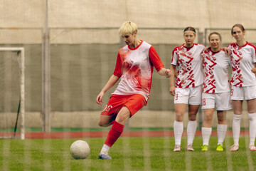 Fototapeta premium Young woman soccer players play football.
