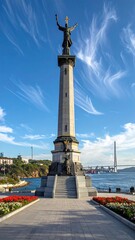 Obraz premium A tall monument with a statue on top near a waterfront