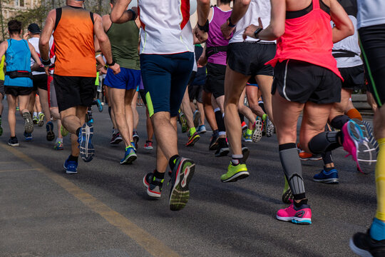Large group of runners running marathon race in Rome