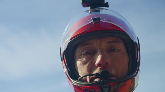 Wingsuit BASE jumper flying over Verbier surrounded by alpine mountains with snow-covered peaks. High-speed flight, dramatic scenery, and cinematic extreme sports action in the Swiss Alps.