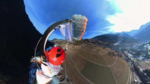 Wingsuit BASE jumper flying over Verbier surrounded by alpine mountains with snow-covered peaks. High-speed flight, dramatic scenery, and cinematic extreme sports action in the Swiss Alps.