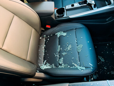 Close up of car seat covered with glass fragments.