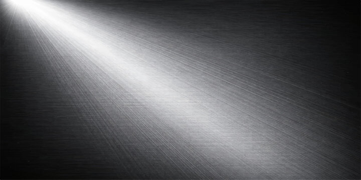 Brushed stainless steel metal texture with a shiny silver aluminum surface and industrial chrome pattern creating a grey metallic background for a sleek dark plate backdrop