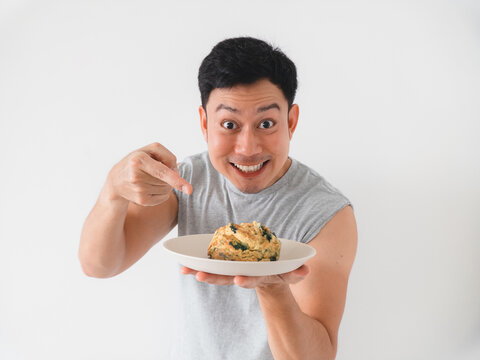 Person sprinkles flavorful seasoning onto prepared plate with enthusiasm
