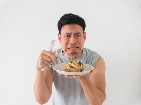 Man displays disappointment and challenge mood after bite