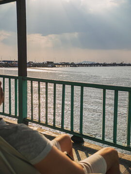Person seated calmly on boat watching sky and shoreline