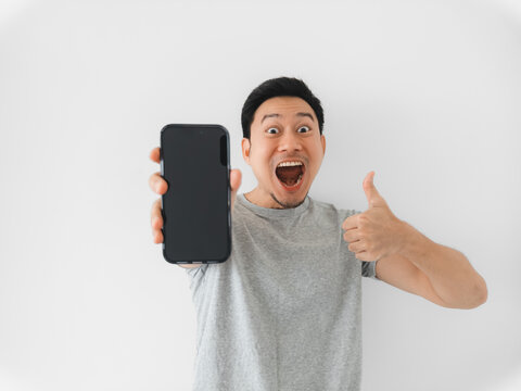 Asian man in gray shirt happily endorsing with thumbs up and smile