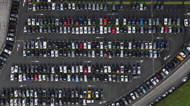Aerial view of a car park densely packed with neatly arranged cars, creating a patterned mosaic of colors and shapes, Porto, Portugal.