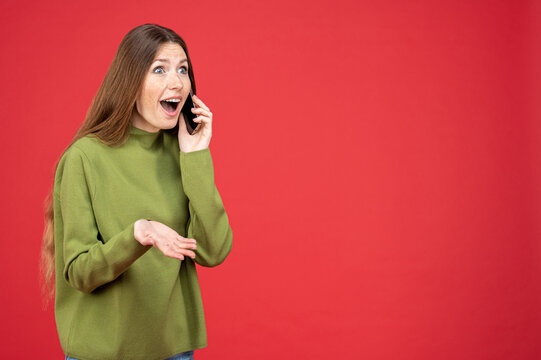 Astonished woman talking on phone looking away at empty space