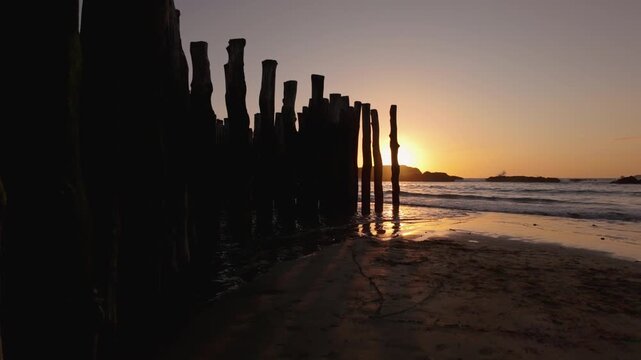Wooden groynes of Saint-Malo at sunset