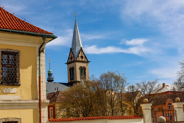 Obraz premium Charming European town square with historic church steeple and yellow building