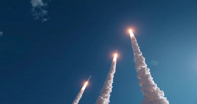 Rockets launching into clear blue sky. Spectacular rocket launch against a clear blue sky with intense flames and smoke