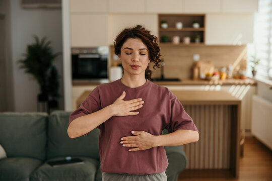 Woman practicing mindful breathing and meditation at home