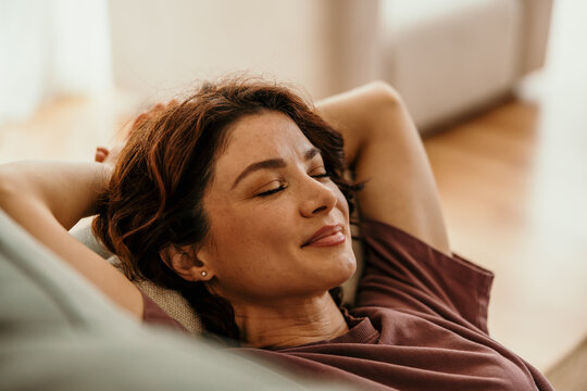 Woman relaxing at home finding peace and tranquility