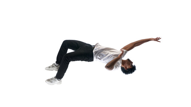 Man bending backward in air isolated on white background abstract motion pose. Concept of flexibility in strategy, adapting to market changes, resilience under pressure, business transformation visual