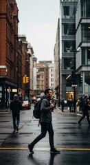 Obraz premium Man walking across street in urban environment.